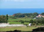 64Zoom_shot_of_white_cliffs_of_Dover_on_other_side_of_English_Channel_with_cemetery_in_the_foreground_Sept15